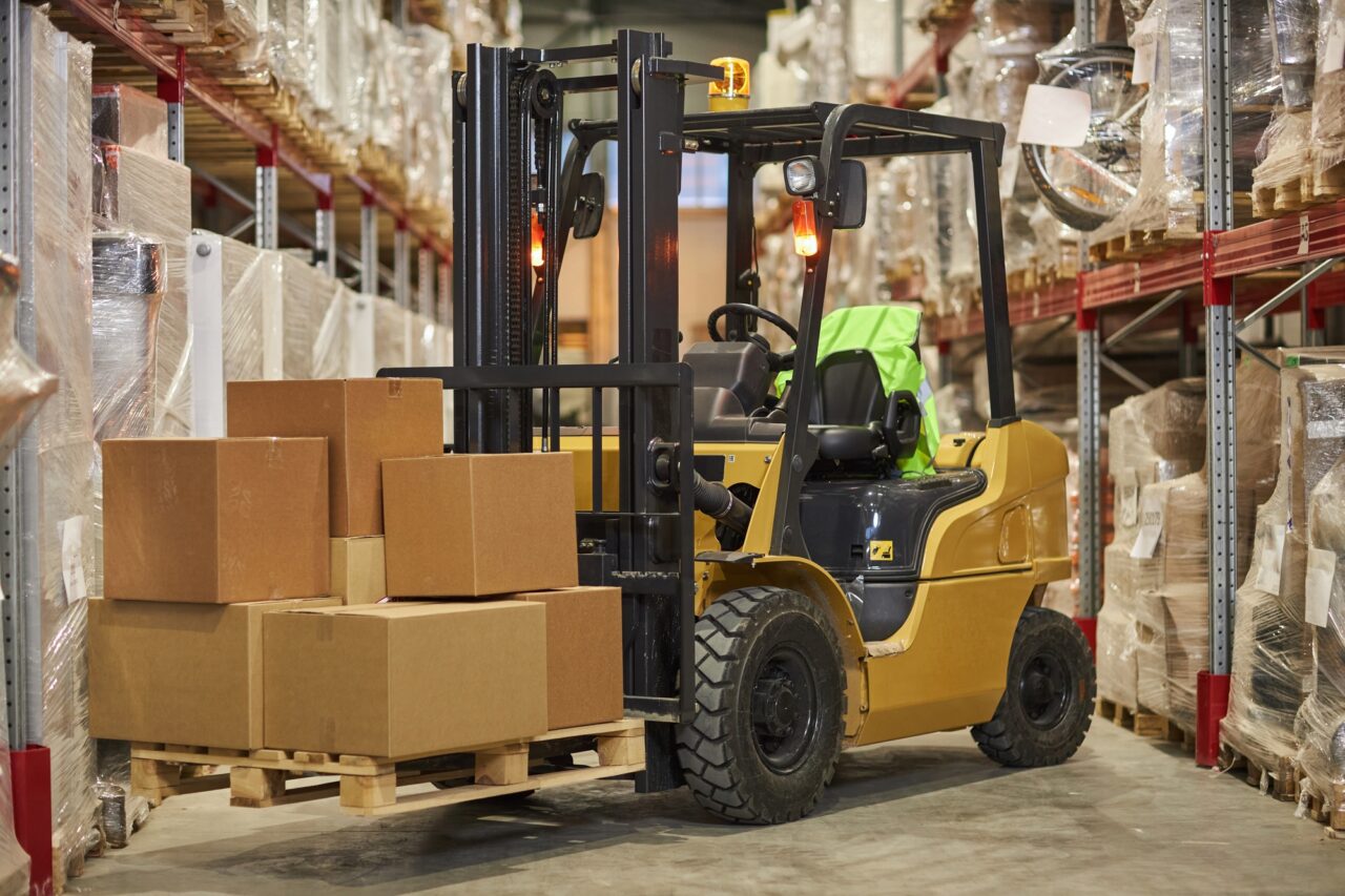 forklift truck carrying boxes in warehouse