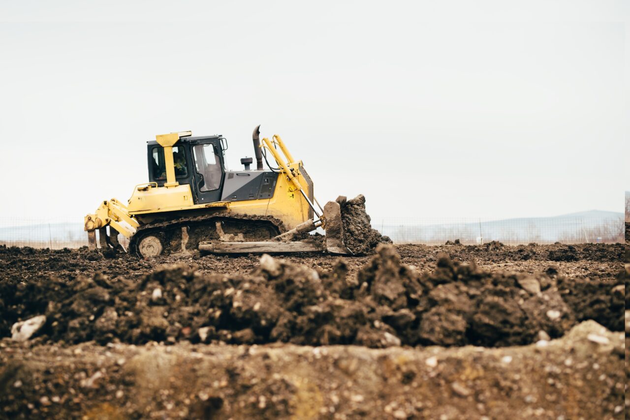 mini industrial bulldozer moving dirt and earth with scoop industrial details of landscaping